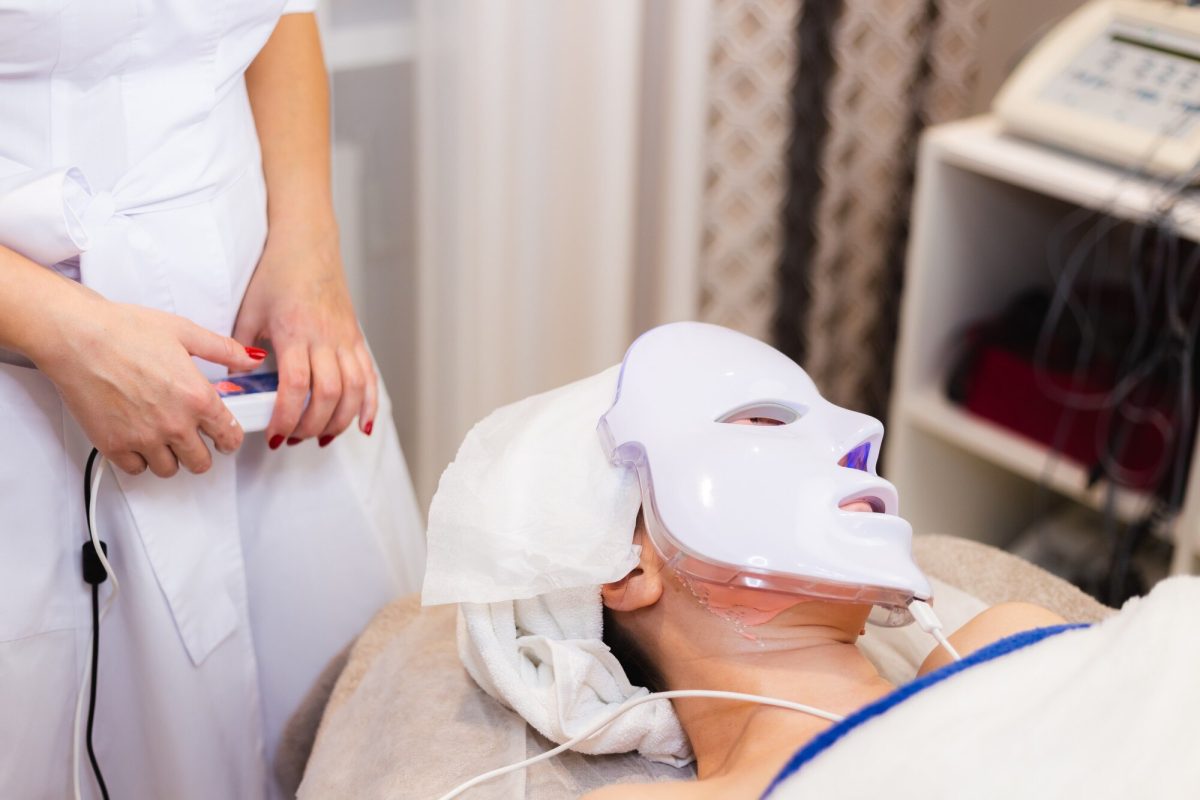 Client receiving a modern facial treatment with LED light therapy